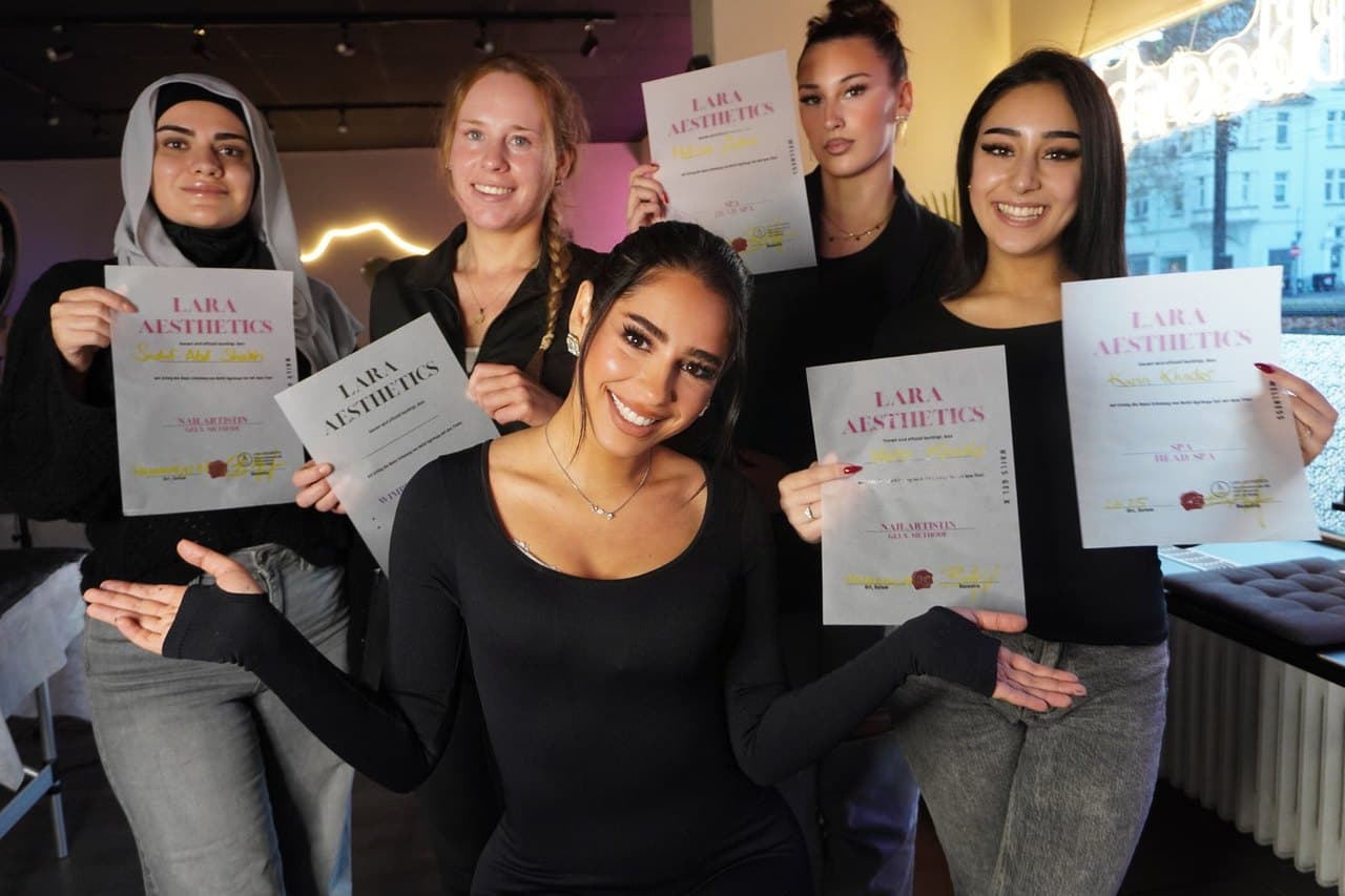 Absolventinnen von Lara Aesthetics halten ihre Zertifikate in die Kamera